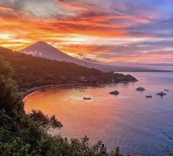 Mount Agung at sunset over Amed bay