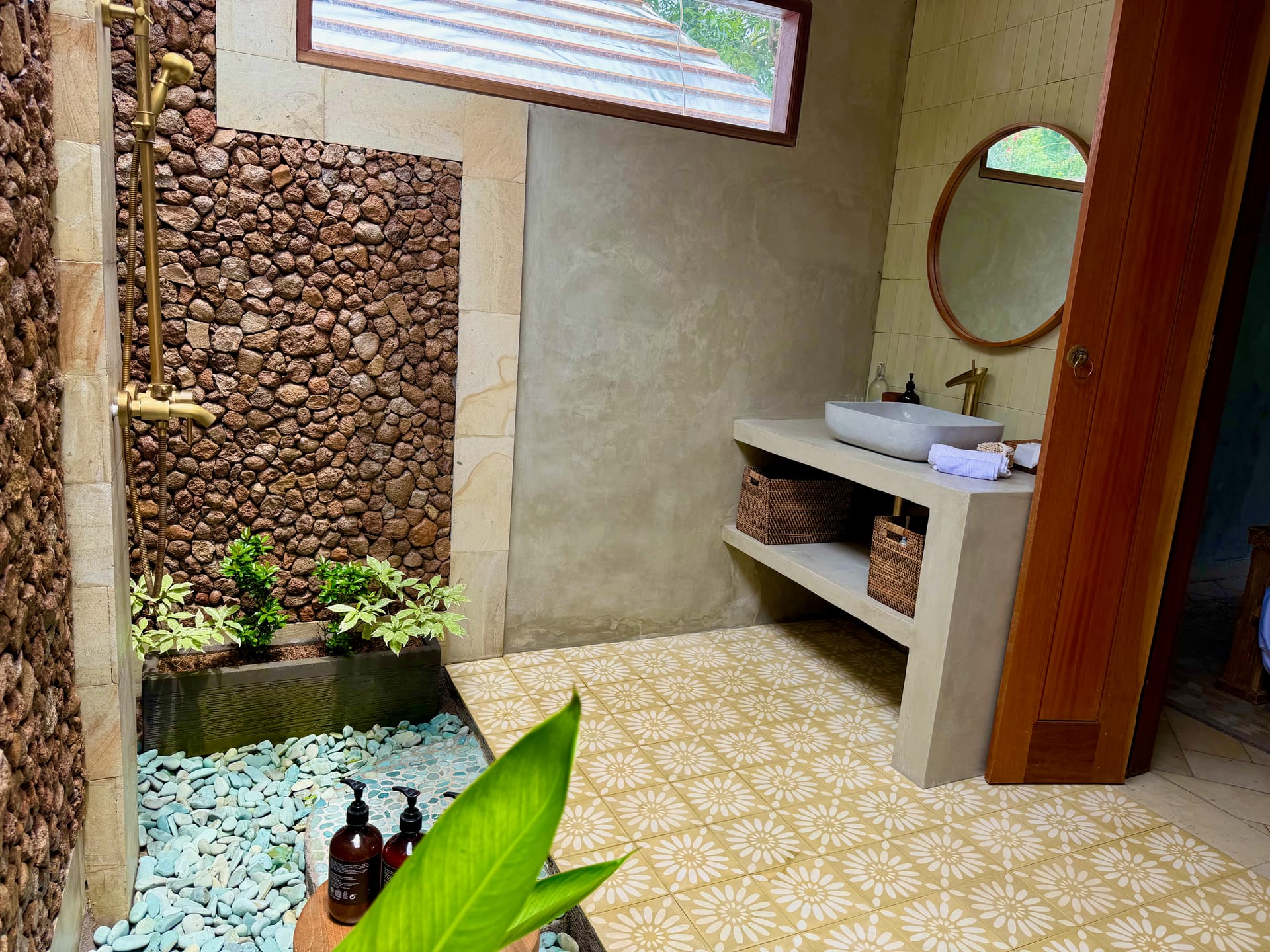 Open-air bathroom with stone-wall shower