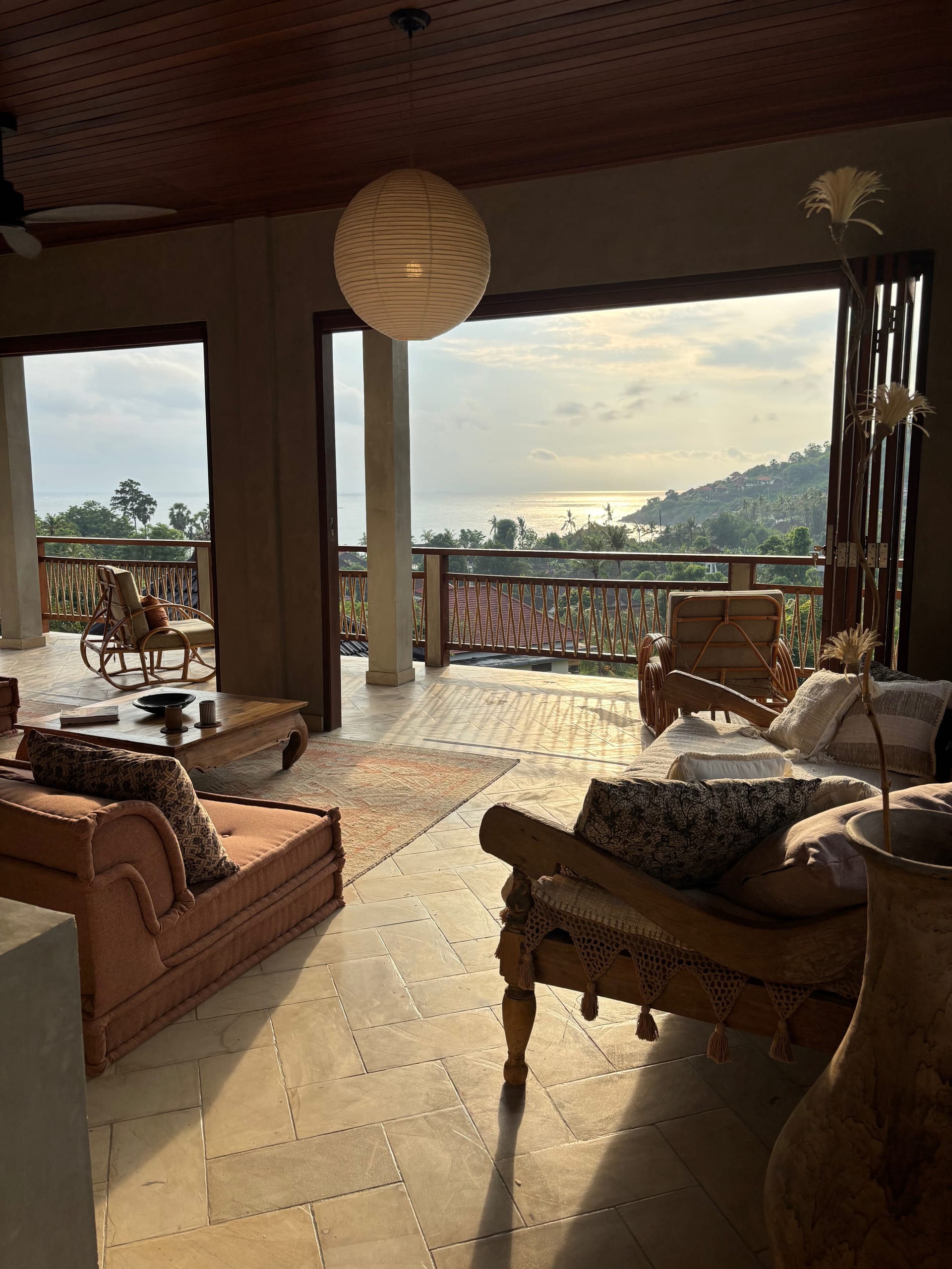 Living room with ocean view at golden hour