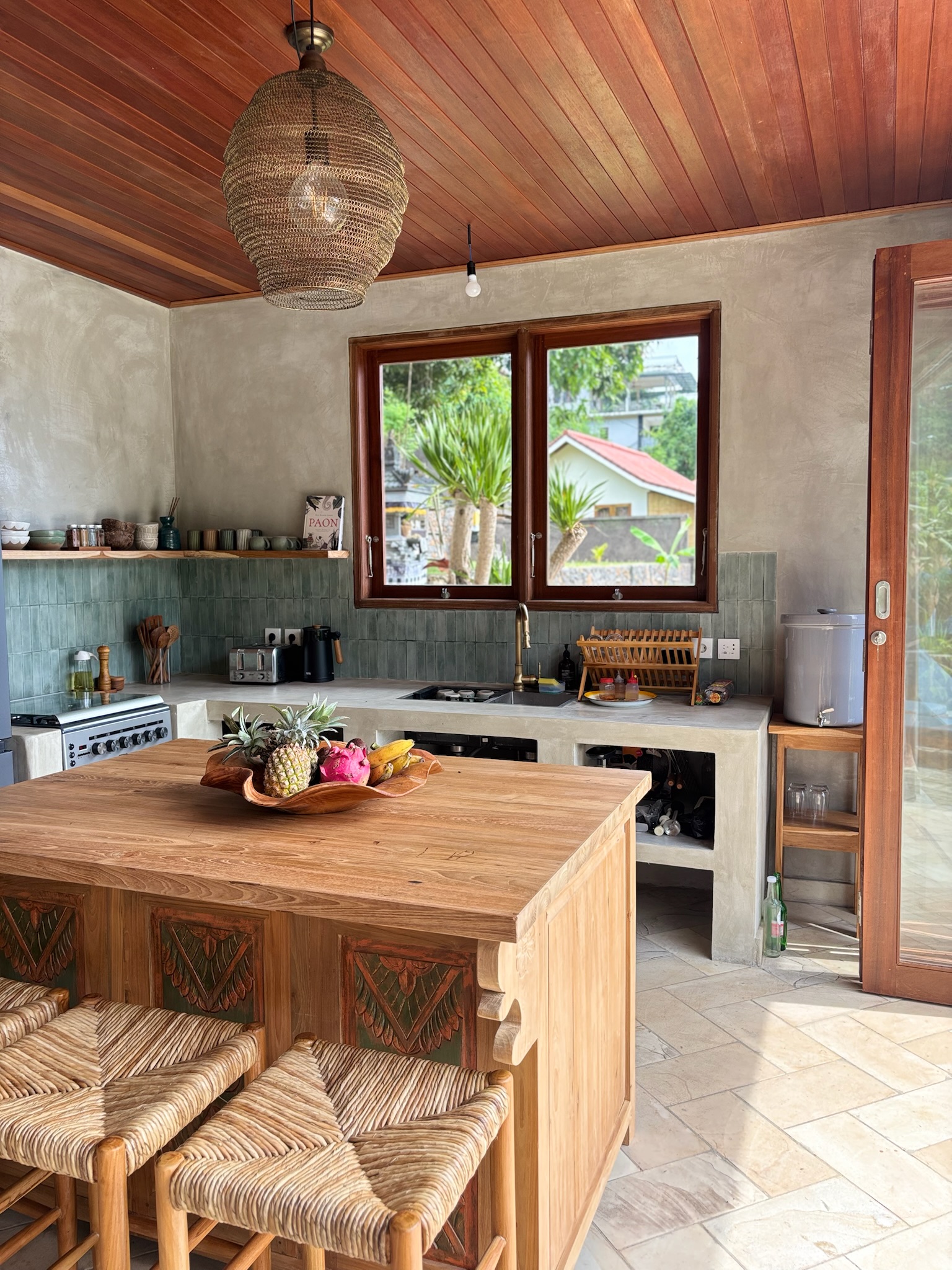 Chef's kitchen with gas stove, large refrigerator and teak island bench