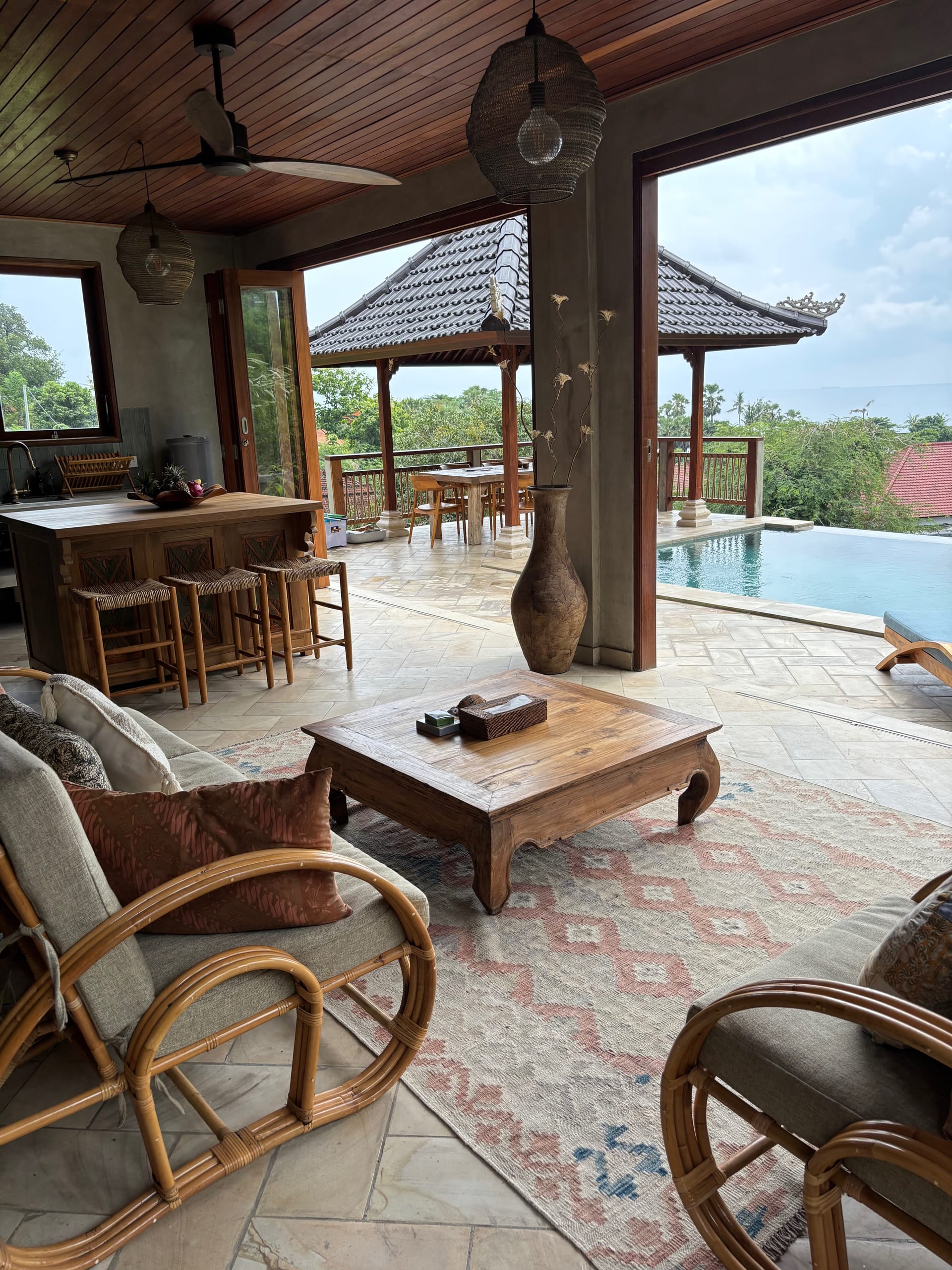 Open-plan living and kitchen with pool view
